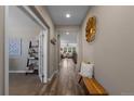Inviting hallway with hardwood floors, neutral walls, and access to various rooms in the home at 549 Tippen Pl, Castle Rock, CO 80104