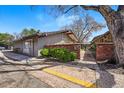 Charming home with a brick entryway and well-maintained landscaping on a sunny day at 6495 E Happy Canyon Rd # 62, Denver, CO 80237