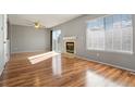 Living room with hardwood floors, fireplace, and sliding glass door access to the patio at 5154 E 126Th Ct, Thornton, CO 80241