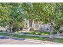 Traditional home with well-manicured front yard and welcoming walkway, framed by mature trees at 9523 Gray Ct, Westminster, CO 80031