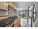 Updated kitchen with stainless appliances, granite counters, and access to the outdoor deck at 9797 E Peakview Ave # C10, Englewood, CO 80111