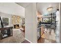 Inviting living room and kitchen featuring a cozy fireplace and an adjacent dining space at 9797 E Peakview Ave # C10, Englewood, CO 80111