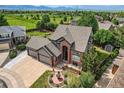 Gorgeous home boasts lush landscaping, mountain views, and an expansive lawn perfect for outdoor activities at 12693 W 82Nd Ln, Arvada, CO 80005
