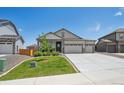 Inviting home with a well-kept lawn, complemented by a three-car garage and a quaint seating area near the front entrance at 14670 Guernsey Dr, Mead, CO 80542
