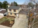 Two-story house with two-car garage, brick facade and tan siding, with a rock and landscaped front yard at 18093 E Milan Pl, Aurora, CO 80013