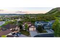 Expansive aerial view of a suburban neighborhood nestled amongst rolling green hills and lush landscaping at 1820 Sapling Ct, Castle Rock, CO 80109