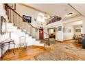 Inviting foyer boasts wood floors, a staircase to the upper level and views into other rooms at 1820 Sapling Ct, Castle Rock, CO 80109