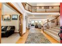 Elegant foyer with wood flooring, a grand staircase, and views into the spacious living areas at 1820 Sapling Ct, Castle Rock, CO 80109