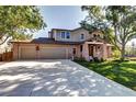 Two-story house with a large driveway and attached garage at 10697 W Roxbury Ave, Littleton, CO 80127