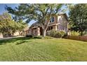 Two story house with mature trees and a spacious yard at 10697 W Roxbury Ave, Littleton, CO 80127