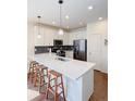 Bright kitchen with a quartz countertop, stainless appliances, and a stylish backsplash at 8951 E 59Th Pl, Denver, CO 80238