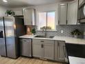 Modern kitchen featuring stainless steel appliances, quartz countertops, and designer backsplash at 7956 Joan Dr, Denver, CO 80221