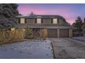 Two-story house with a brown exterior, two-car garage, and solar panels on the roof at 7261 E Hinsdale Ave, Centennial, CO 80112