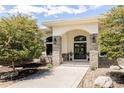 A stately home exterior showcasing a stone facade, archway and double door entry at 8937 Little Raven Trl, Niwot, CO 80503