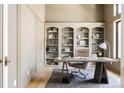 Inviting home office featuring built-in bookshelves, a cozy chair and a window at 8937 Little Raven Trl, Niwot, CO 80503