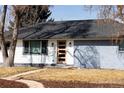 Charming single-story home featuring a modern front door, updated facade, and well-maintained lawn on a sunny day at 555 W Peakview Ave, Littleton, CO 80120