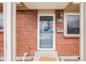 Close-up of the brick front exterior with the front door at 8331 Mason Cir, Westminster, CO 80031