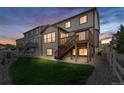 A multi-level deck and lush lawn create an inviting outdoor living space in this beautifully maintained backyard at 2668 Scoter Ln, Castle Rock, CO 80104