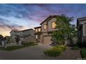 Beautiful two-story home features manicured landscaping, an attached two-car garage, and a welcoming facade at 2668 Scoter Ln, Castle Rock, CO 80104