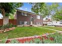 Beautiful brick home with lush green lawn, flower beds, and a well-kept landscape and exterior at 11855 Humboldt Dr, Northglenn, CO 80233
