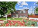 Lovely brick home featuring a well-manicured lawn, vibrant flowerbeds and inviting curb appeal at 11855 Humboldt Dr, Northglenn, CO 80233