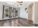 Bright living room with hardwood floors, large windows, and an elegant archway at 14400 Albrook Dr # 43, Denver, CO 80239