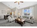 Bright living room featuring neutral tones, comfortable sofas, large windows, and a view of the neighborhood at 22610 E Ontario Dr # 204, Aurora, CO 80016