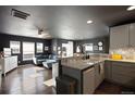 Open concept kitchen and living area with modern finishes at 12831 Mayfair Way # F, Englewood, CO 80112