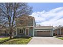 Charming two-story home with a well-maintained lawn and attached garage. Garage number is 381 at 381 Tynan Dr, Erie, CO 80516