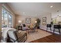 Cozy living room with a large window, hardwood floors and modern decor at 381 Tynan Dr, Erie, CO 80516