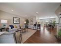 Spacious living room flows into the kitchen and dining area with hardwood floors at 381 Tynan Dr, Erie, CO 80516
