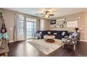 Bright living room featuring hardwood floors, a ceiling fan, and sliding glass doors to the patio at 1560 Olympia Cir # 108, Castle Rock, CO 80104
