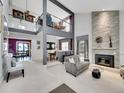 Inviting living room with stone fireplace, stylish decor, and an open concept design at 2590 W Long Cir, Littleton, CO 80120