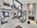 Stylish living room featuring high ceilings, stone fireplace, and open floor plan at 2590 W Long Cir, Littleton, CO 80120