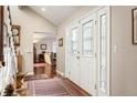 Bright entryway with hardwood floors and stained glass doors at 4530 S Verbena St # 309, Denver, CO 80237