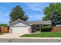 Inviting ranch-style home with a well-kept lawn and a convenient two-car attached garage at 7325 S Houstoun Waring Cir, Littleton, CO 80120