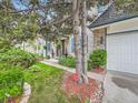 Inviting front yard with lush landscaping, mature trees, and a brick pathway leading to the front door at 12610 E Villanova Dr, Aurora, CO 80014