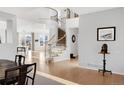 Elegant foyer with a curved staircase and hardwood floors at 13753 Jasmine St, Thornton, CO 80602