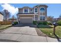 Charming two-story home with a well-manicured lawn, mature landscaping, and a spacious driveway at 10732 Cook Ct, Northglenn, CO 80233