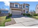 Charming two-story home with a well-manicured lawn, mature landscaping, and a spacious driveway at 10732 Cook Ct, Northglenn, CO 80233
