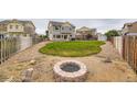 Spacious backyard with a well-manicured lawn, fire pit, and ample space for outdoor activities at 12981 E 108Th Way, Commerce City, CO 80022