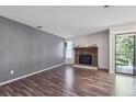 Spacious living room with hardwood floors, stone fireplace, and natural light at 10950 W Florida Ave # 314, Lakewood, CO 80232