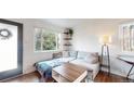 Cozy living room with a large window, stylish furniture, and modern decor at 3155 N Steele St, Denver, CO 80205