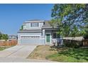 Two-story house with gray siding, green door, and a landscaped lawn at 20493 E Hampden Pl, Aurora, CO 80013