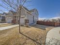 Exterior view of the property featuring well-maintained lawn and fence at 10371 Harrisburg St, Parker, CO 80134
