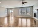 Bright living room with wood floors, modern fireplace, and sliding glass door to the outdoor space at 10371 Harrisburg St, Parker, CO 80134