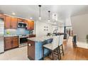 Open-concept kitchen featuring stainless steel appliances, a granite island, and bar stool seating at 7476 E Arkansas Ave # 35-01, Denver, CO 80231