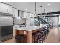 Stylish kitchen with a center island, stainless steel appliances, modern lighting, and barstool seating at 3636 Lipan St, Denver, CO 80211