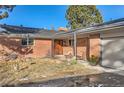 Front view of a ranch house with a covered entryway at 558 S Pontiac Way, Denver, CO 80224