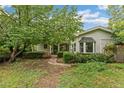 Inviting home featuring mature trees, well-maintained landscaping, and a charming bay window at 1900 S Gilpin St, Denver, CO 80210